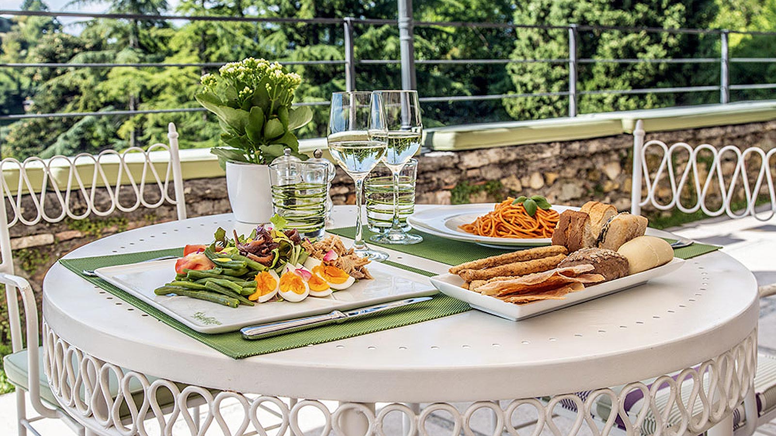 Bar table with tasty dishes and garden view